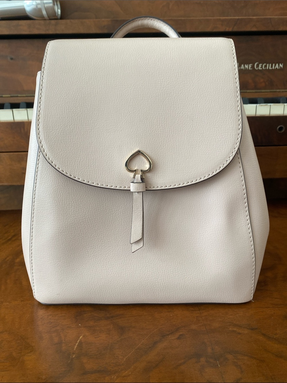 kate spade Pebbled Mini Backpack in Light Cream with Spade Accent